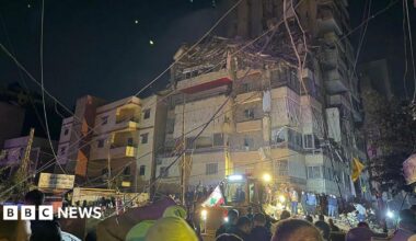 Emergency service workers outside a damaged building in Beirut
