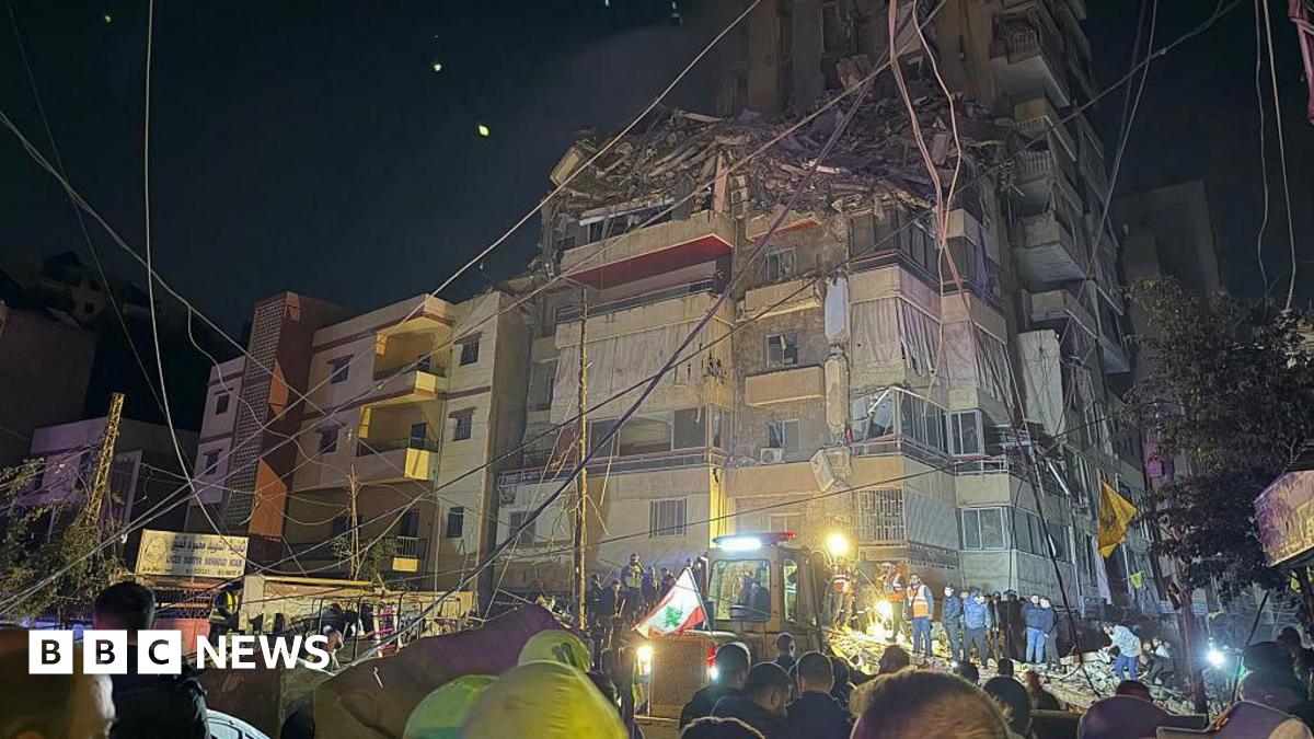 Emergency service workers outside a damaged building in Beirut