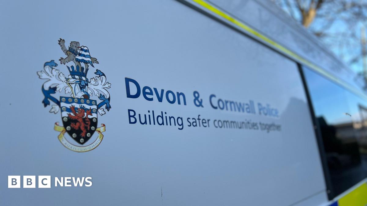 Side of a police van with the emblem and sign for Devon and Cornwall Police.