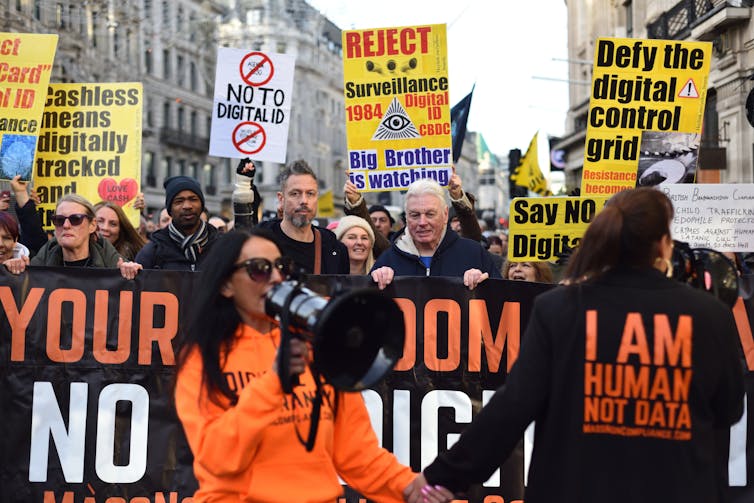 A crowd of people protesting against digital ID