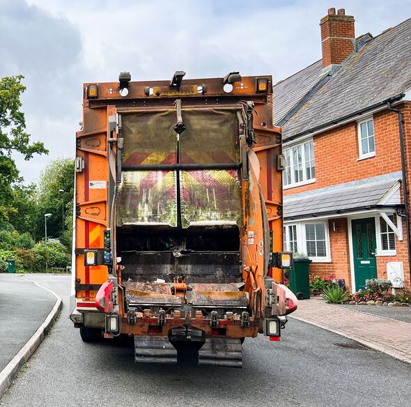 Garbage truck doing rubbish collection on residential street Garbage truck doing rubbish collection on residential street
