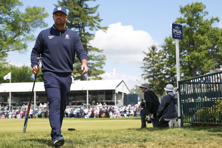 Bryson DeChambeau walks off the 18th green Thursday.
