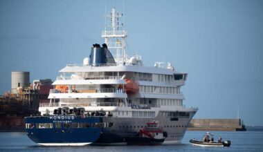 The Dutch-flagged hantavirus-stricken cruise ship MV Hondius after it arrived at the industrial port of Granadilla de Abona, on the island of Tenerife, in Spain's Canary Islands on 10 May.  Now, three Zimbabwean health care workers identified as contacts on Ascension Island have been flown home under strict quarantine measures.