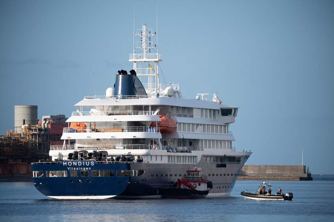 The Dutch-flagged hantavirus-stricken cruise ship MV Hondius after it arrived at the industrial port of Granadilla de Abona, on the island of Tenerife, in Spain's Canary Islands on 10 May. Now, three Zimbabwean health care workers identified as contacts on Ascension Island have been flown home under strict quarantine measures.