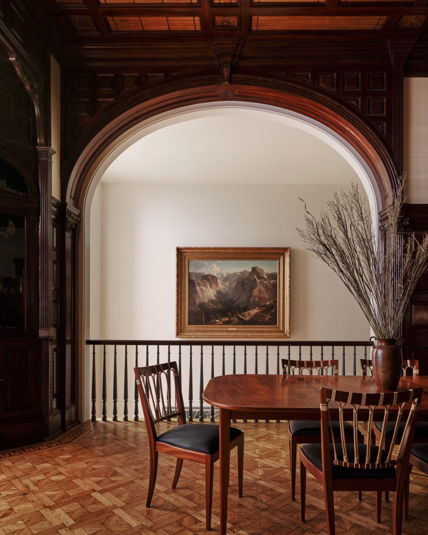 A room with an arched opening and intricate parquet flooring
