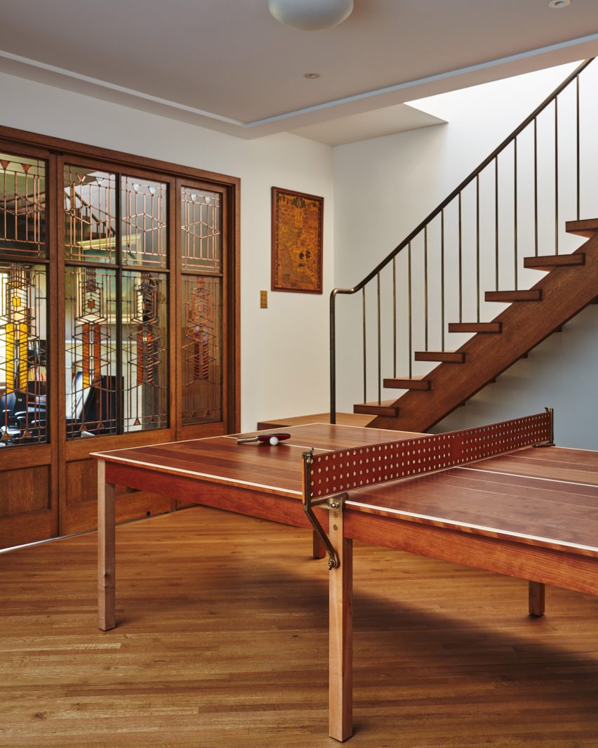Room with patterned-glass door inserts and a wooden ping pong table