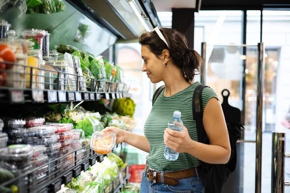 Portrait of a young woman buying fresh, organic vegetables at the neighboring grocery store Portrait of a young woman buying fresh, organic vegetables at the neighboring grocery store