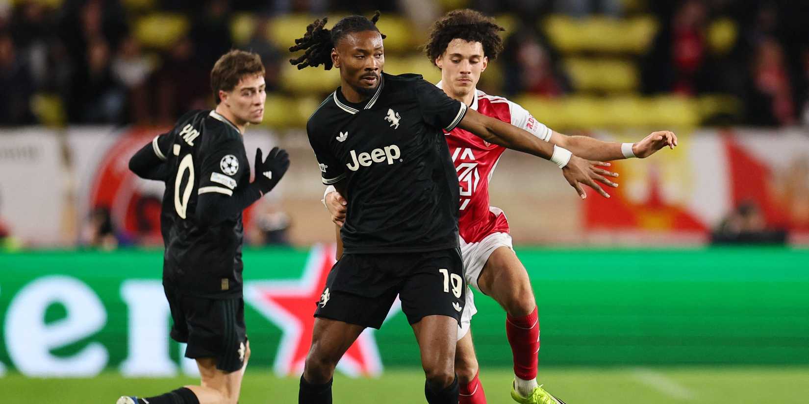 Juventus' Khephren Thuram in action with AS Monaco's Maghnes Akliouche
