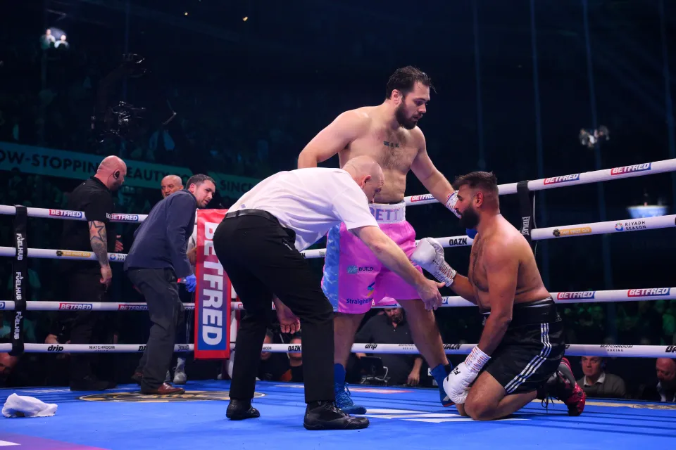 Karim Berredjem is checked on by Dave Allen and the Referee after he is knocked down by Dave Allen during the Heavyweight fight during the Last Man Standing: Leigh Wood v Josh Warrington fight night at Motorpoint Arena Nottingham on February 21, 2026 in Nottingham, England