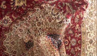a detail of a large wall sculpture by Debbie Lawson made from ornamental woven carpet, with the silhouette of an eagle flying out of the center