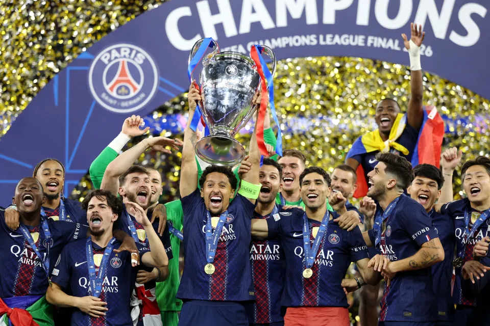 Paris Saint-Germain lift the Champions League trophy.