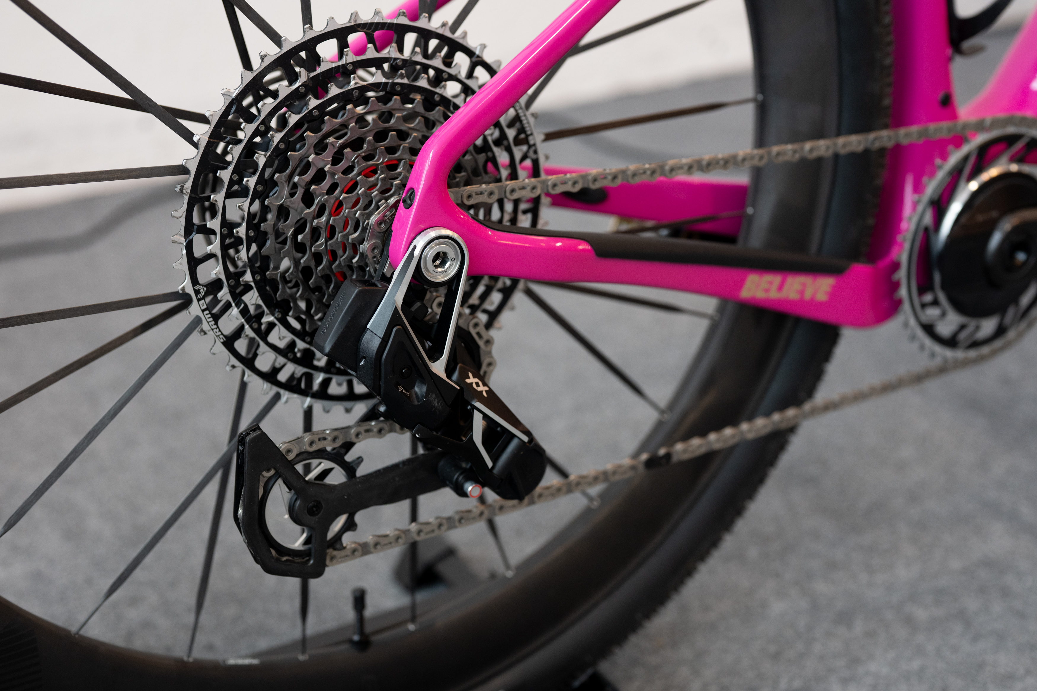Closeup of the rear mech of this bright pink bike