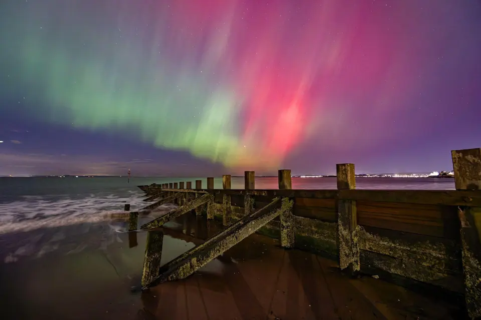 The Northern Lights visible over a groyne on the beach at Portobello near Edinburgh, Scotland.