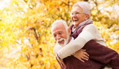 Retired couple hugging and laughing.