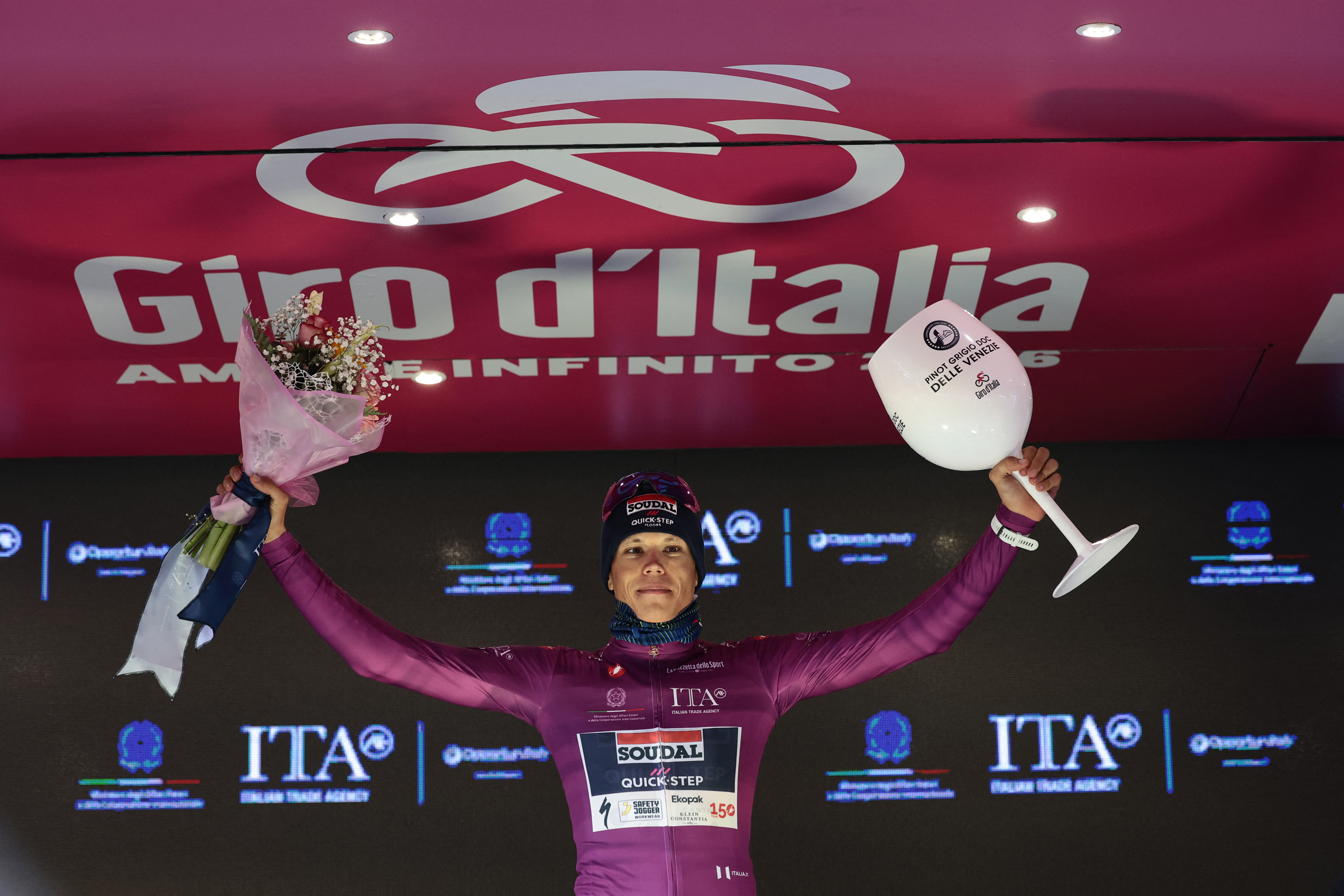 Soudal Quick-Step French rider Paul Magnier, wearing the points classification mauve jersey (Maglia Ciclamino), celebrates on the podium for the 9th stage of the Giro d'Italia 2026 - Tour of Italy cycling race between Cervia and Corno alle Scale, near Doganaccia, central Italy on May 17, 2026. (Photo by Luca Bettini / AFP)