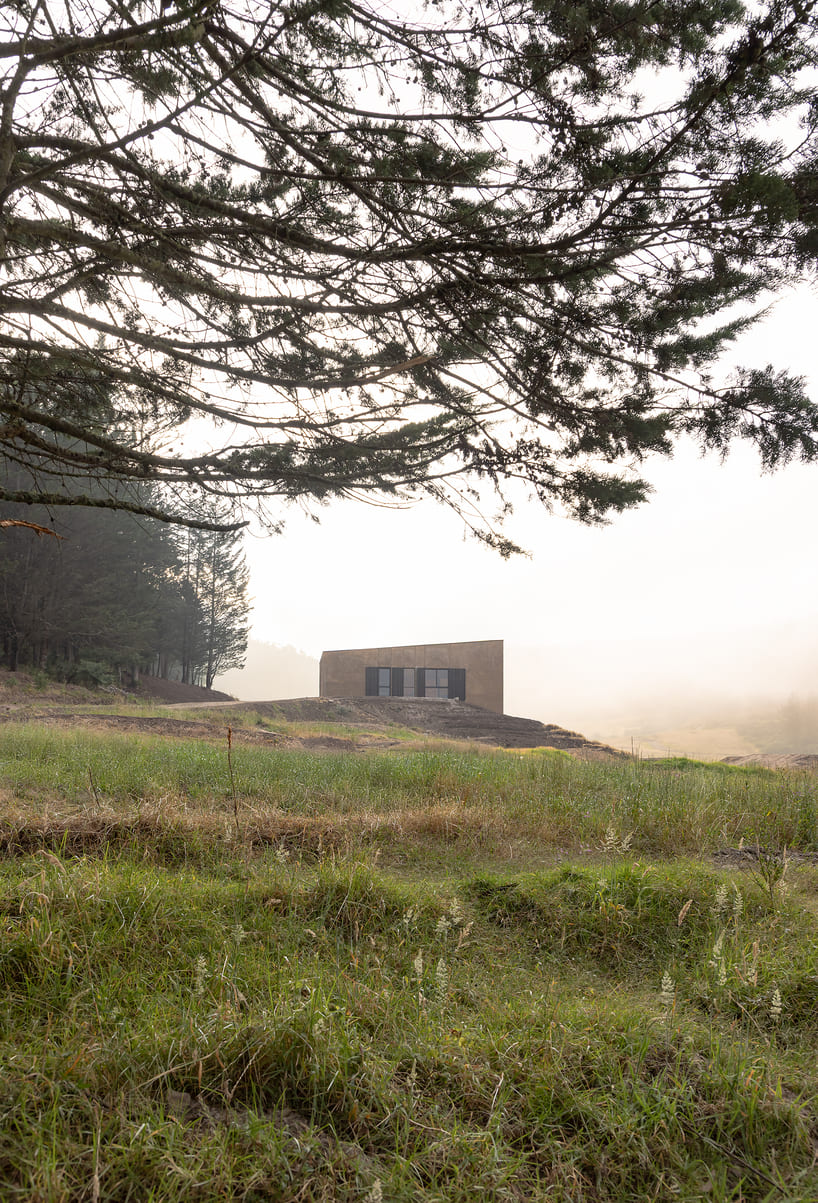 earth-toned concrete bike refuge emerges from ecuador’s reforested landscape - 4