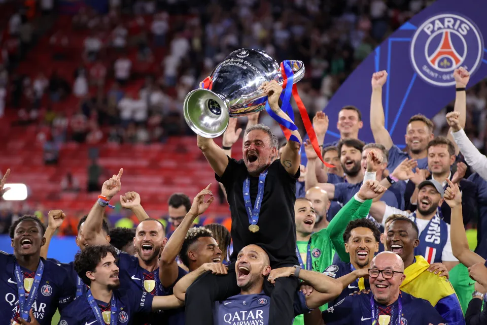 Paris Saint Germain manager Luis Enrique celebrates and is held aloft with the trophy during the UEFA Champions League Final 2026 match between Paris Saint-Germain and Arsenal