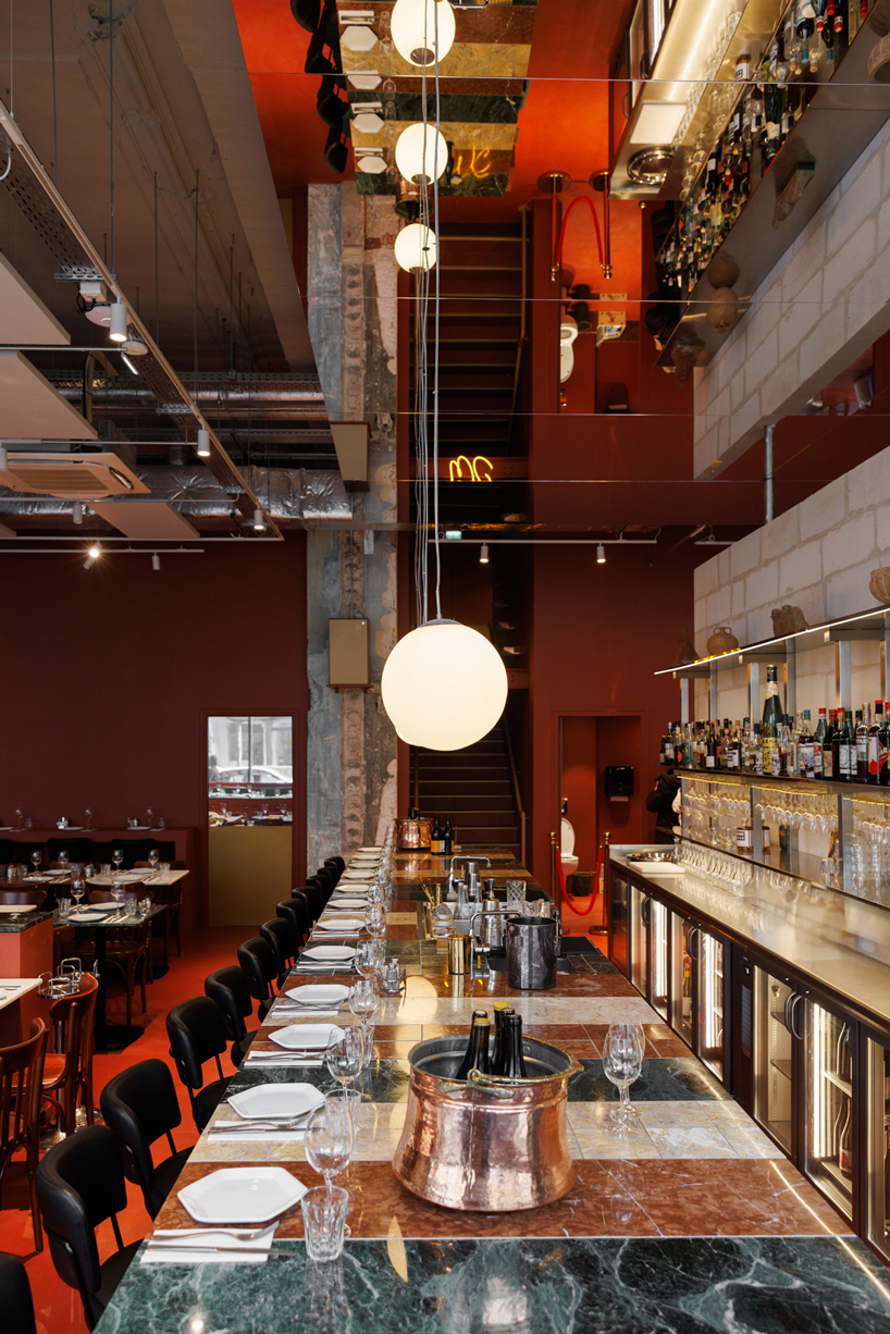red floor anchors parisian restaurant ypseli with steel and marble textures - 5