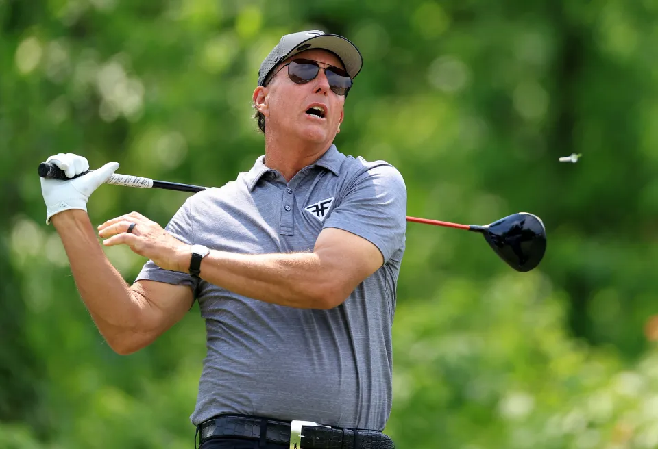 Phil Mickelson reacts after hitting a shot