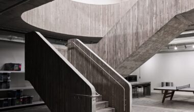 Concrete staircase anchors Purple Brand studios by Scott & Scott Architects