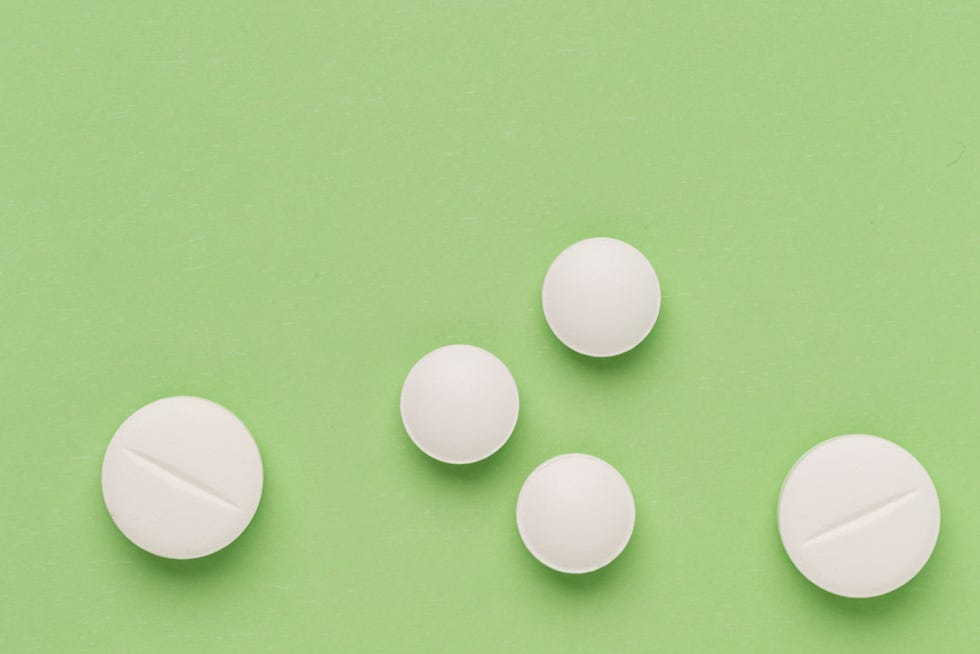 Round white pills on colorful background Round white pills on colorful background
