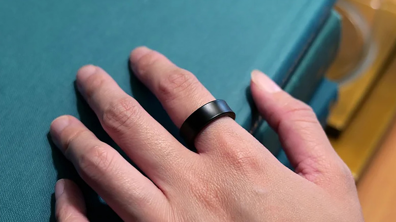 The Samsung Galaxy Ring on a person's right index finger
