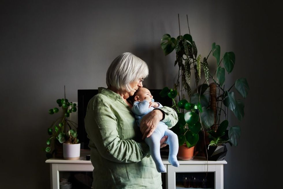 SENIOR WOMAN HOLDING BABY
