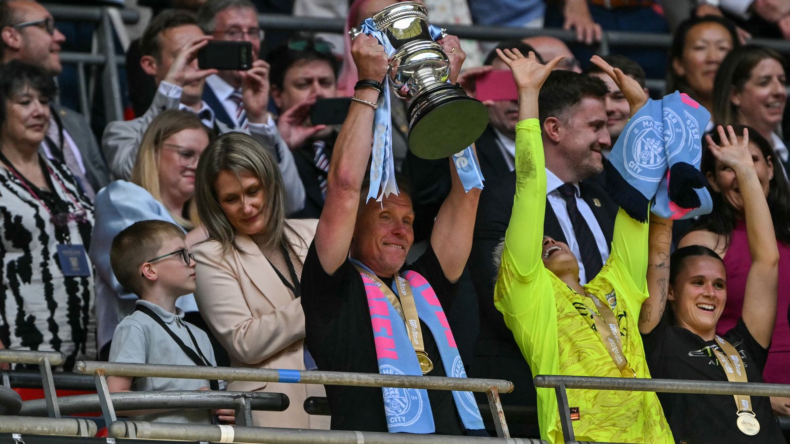 Man City boss Andree Jeglertz lifts the Women's FA Cup - his second trophy this season