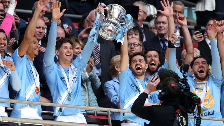 John Stones and Bernardo Silva lift the FA Cup following Man City's 1-0 win against Chelsea