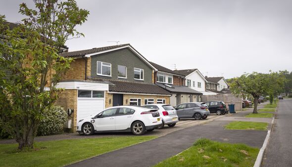 Suburban houses with cars parked on driveway, Pinner, London, UK Suburban houses with cars parked on driveway, Pinner, London, UK
