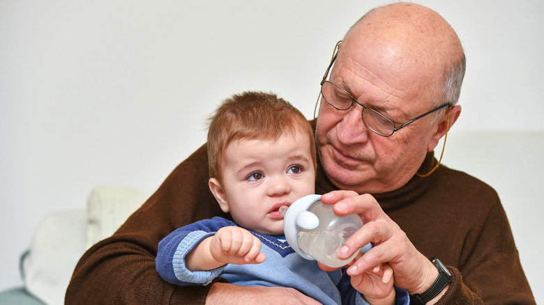 A man feeding a child