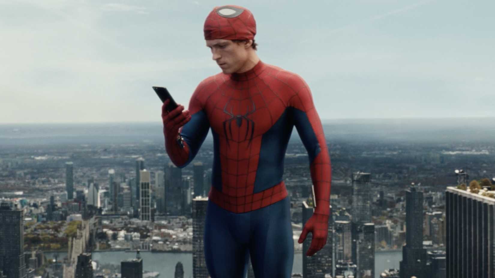 Tom Holland as Spider-Man in Brand New Day looking at his phone