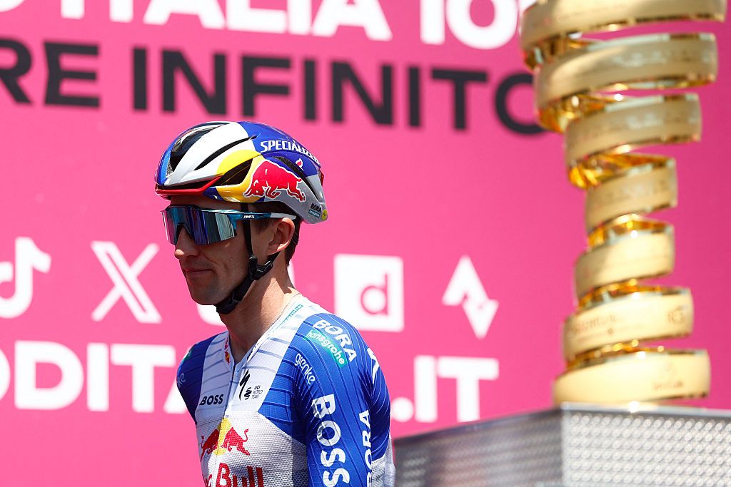 Red Bull - BORA - hansgrohe Australian rider Jai Hindley walks past the trophy on stage before the 15th stage of the Giro d'Italia 2026 - Tour of Italy cycling race between Voghera and Milan, Italy, on May 24, 2026. (Photo by Luca Bettini / AFP)