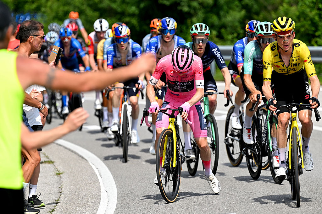 Vingegaard slows to a stop to check his front tyre