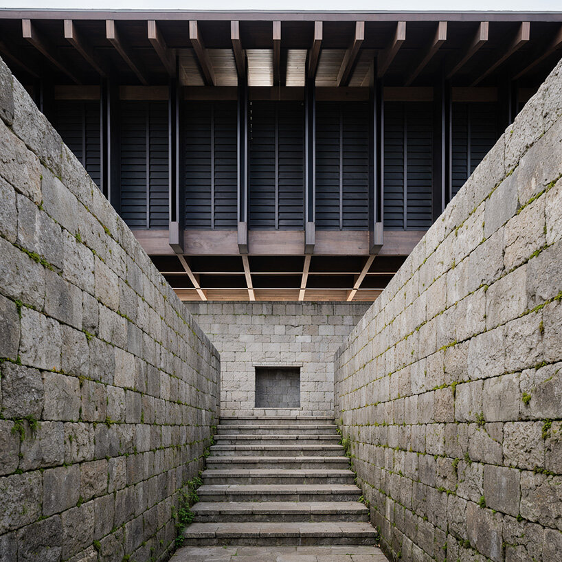 V taller proposes forest retreat around monolithic stone core for NOT A HOTEL in japan - 4