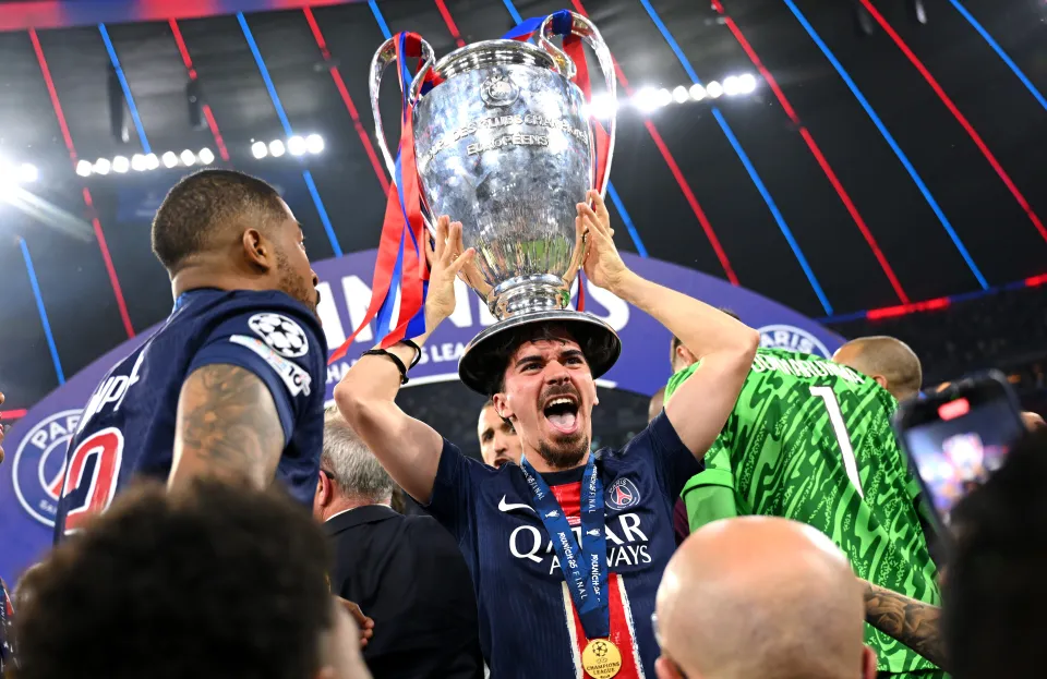 Vitinha lifting the Champions League trophy