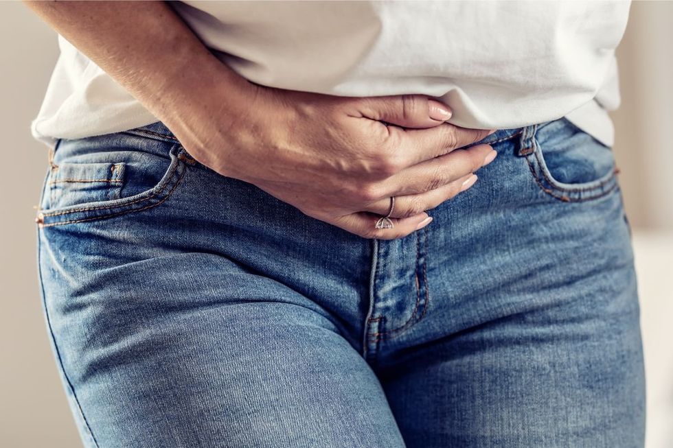 Woman clutching lower stomach