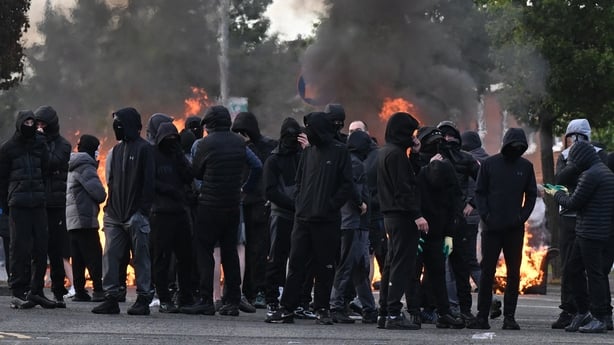 Youths gather infront of a burning barricade on Duncairn Gardens in Belfast.