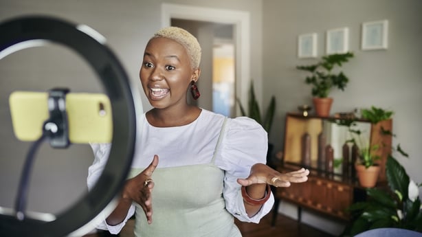 Smiling young Black female influencer