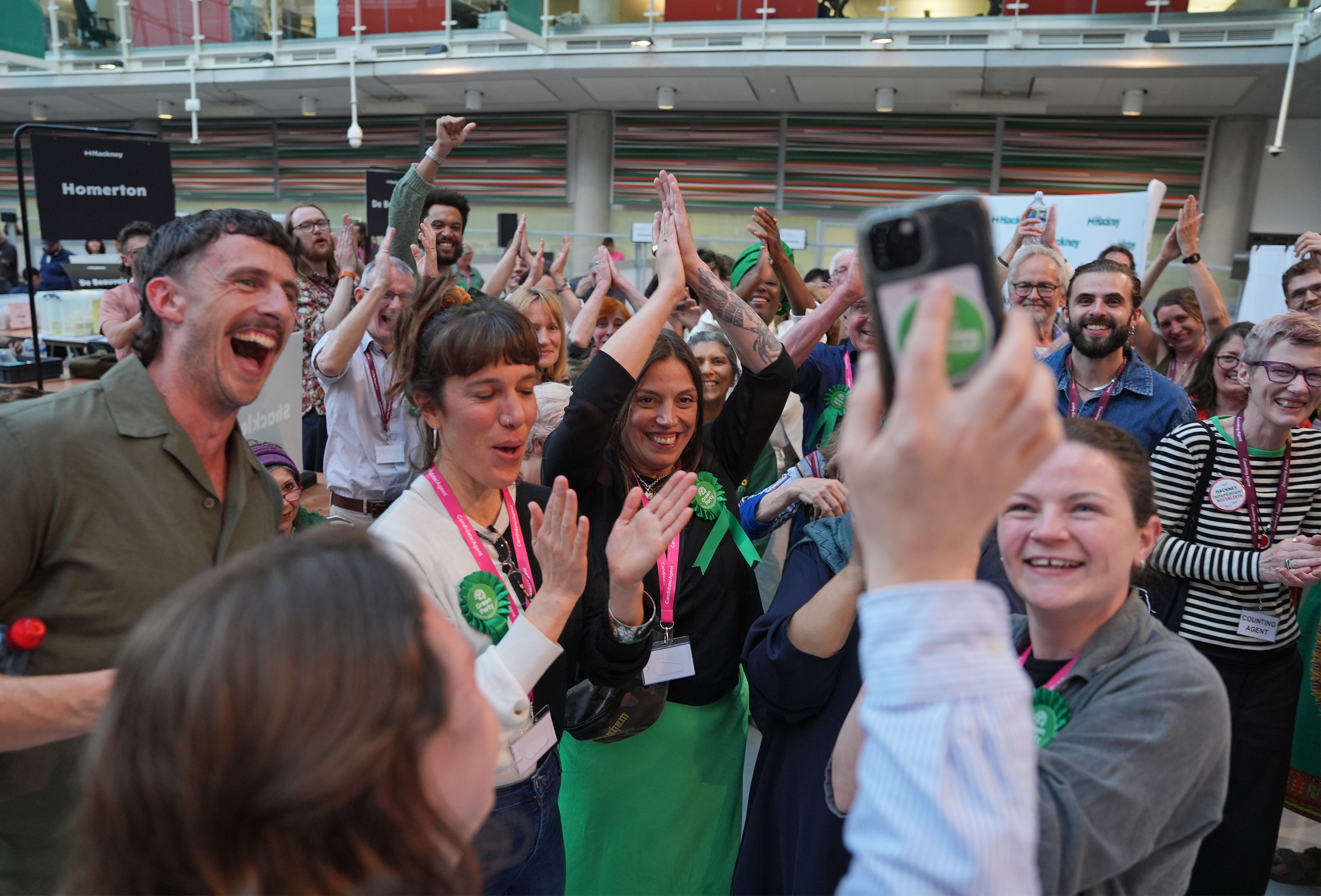 Green Party supporters celebrate the results of the Hackney council elections