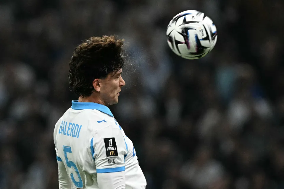 Leonardo Balerdi heads the ball for Marseille