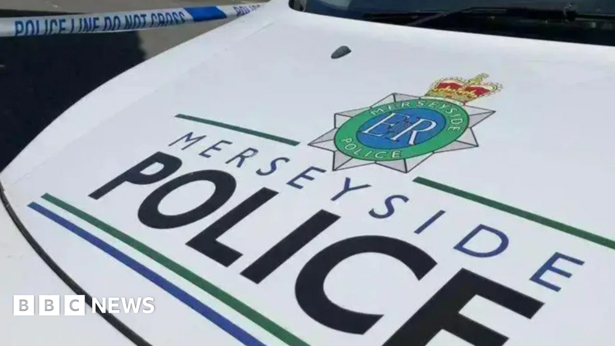 Stock shot of the bonnet of a Merseyside Police van, which is white. The text 'MERSEYSIDE POLICE' is seen on the front in black and blue lettering.