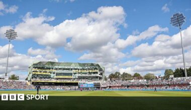 Headingley Cricket Ground with the pavilion in the centre and floodlights either side.