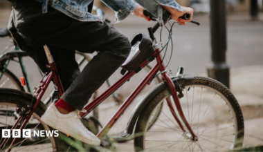 A stock image of someone on a bike. Only their legs are visible.