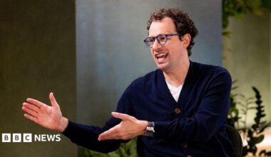 Dario Amodei, co-founder and chief executive officer of Anthropic, speaking during an interview in a room decorated with plants