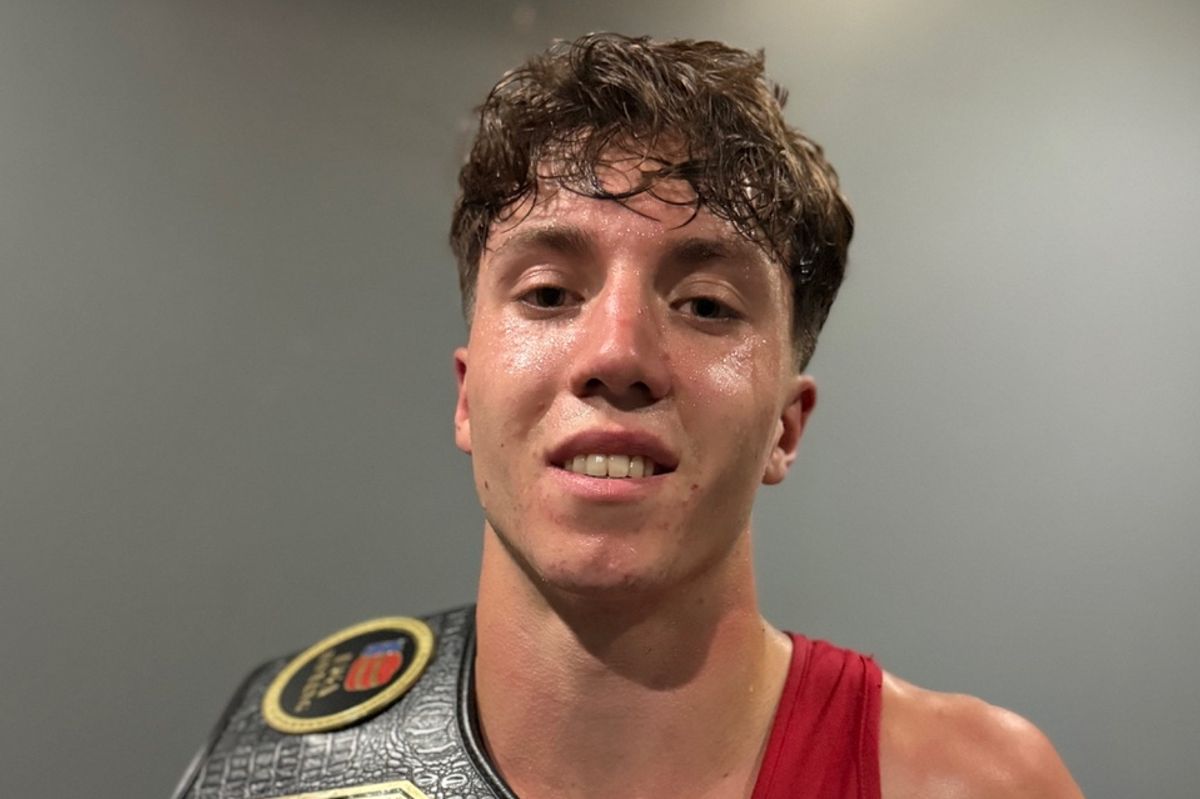 Saul Matchett poses not long after his winning bout with his belt and a clenched fist