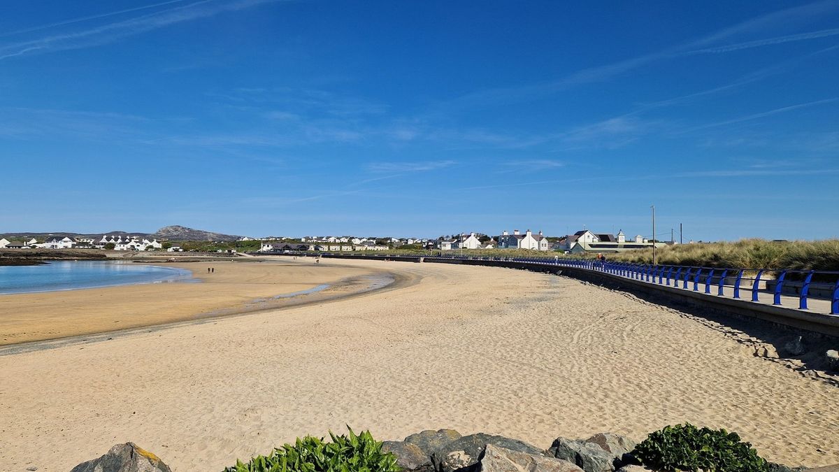 Trearddur Bay's sandy beach and gently sloping waters