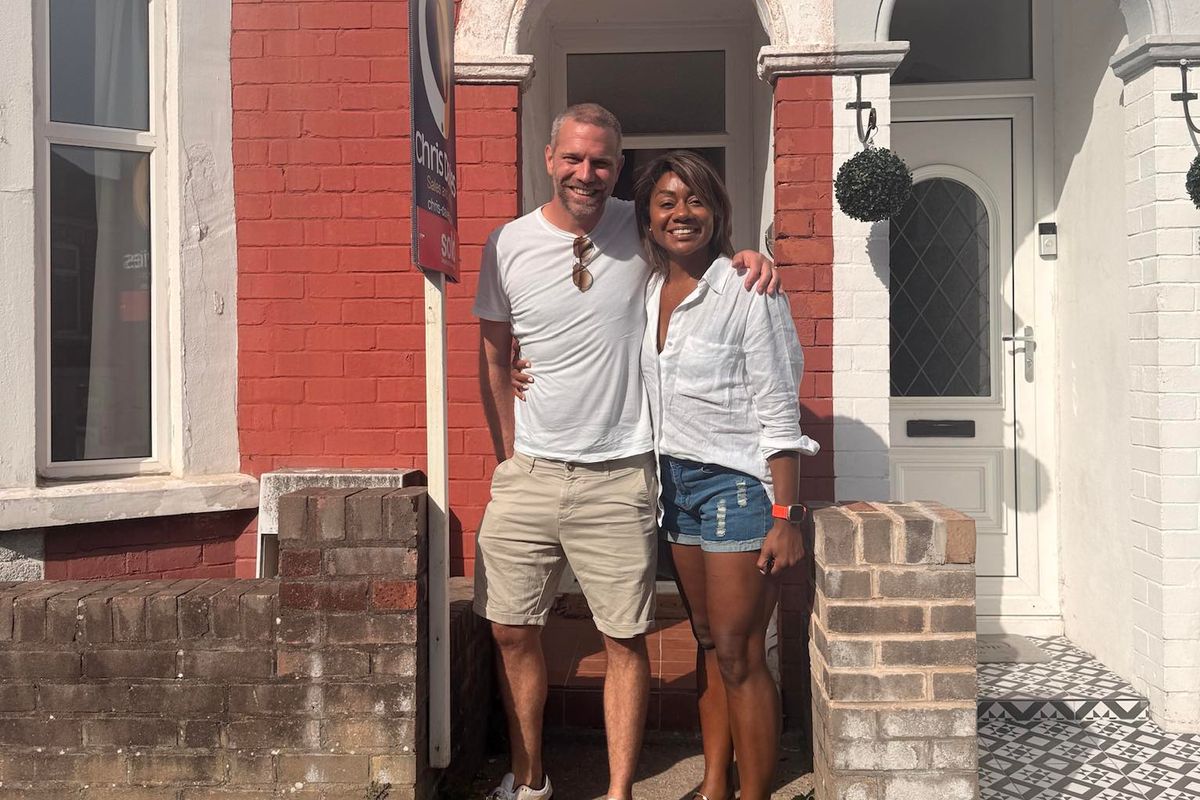 Couple stood outside of terraced house