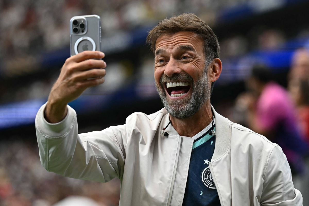 Former Liverpool head coach Jurgen Klopp takes a selfie during the 2026 World Cup Group E football match between Germany and Curacao at the Houston Stadium in Houston on June 14, 2026.  (Photo by Paul ELLIS / AFP via Getty Images)
