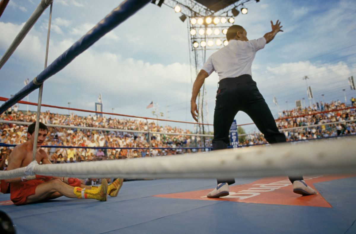 Irish boxer Barry McGuigan (left) on the canvas during his defence of his WBA world featherweight title against Steve Cruz of the USA, at Caesars Palace, Las Vegas, 23rd June 1986